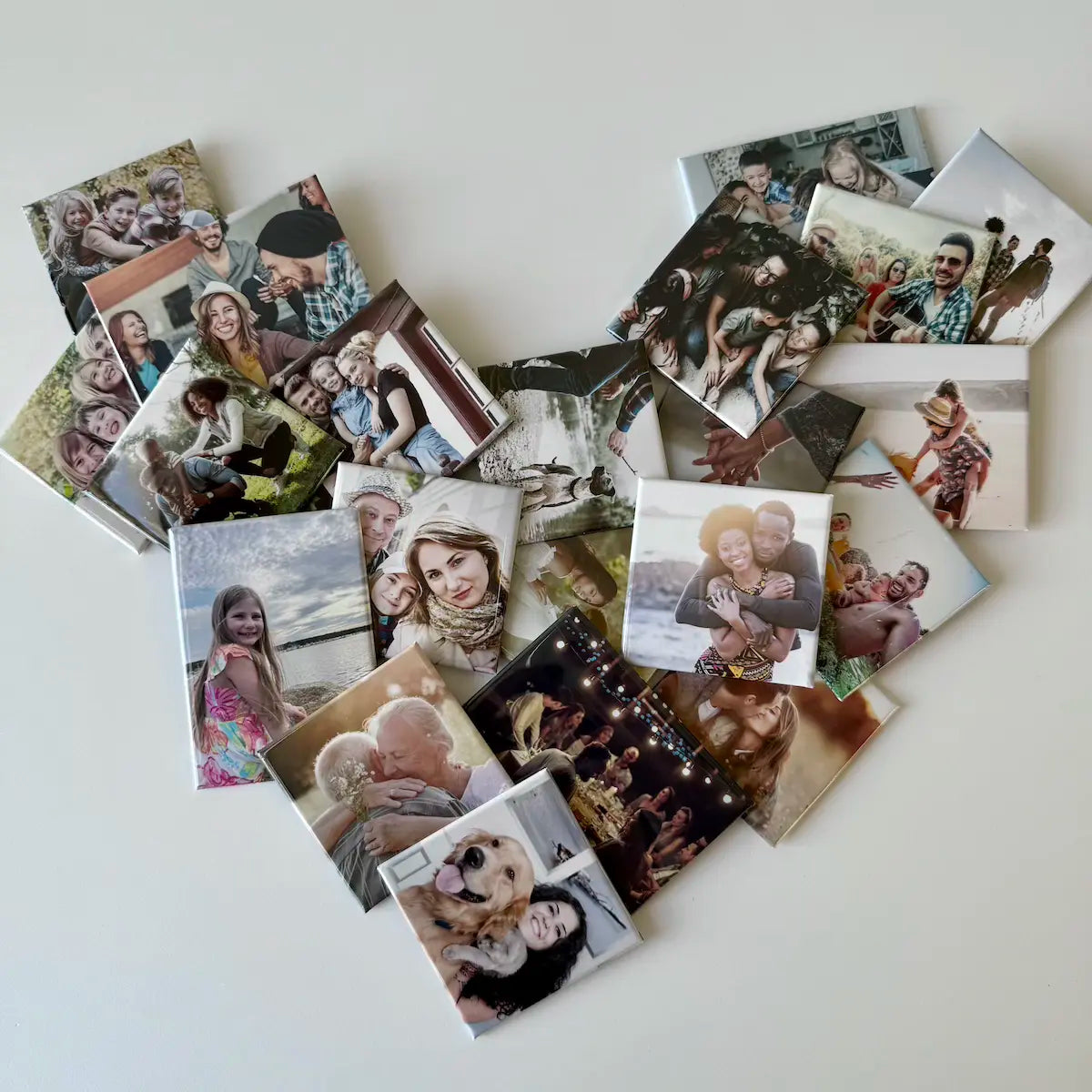 Custom photo magnets by Milestone Magnets arranged in a heart shape, featuring family memories for fridge display, boards, and keepsake gift ideas. 
